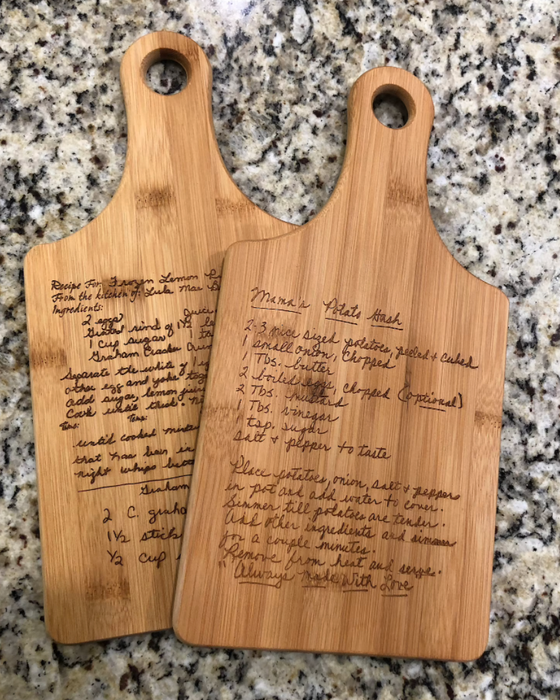 Two cutting boards engraved with handwritten recipes, turning precious memories into functional art.