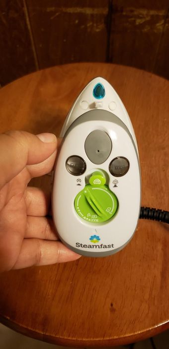 A top-down view of the mini iron, showcasing the buttons.