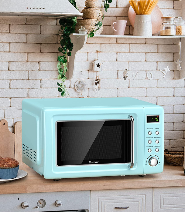 The light blue microwave sitting on a kitchen counter, ready to serve.