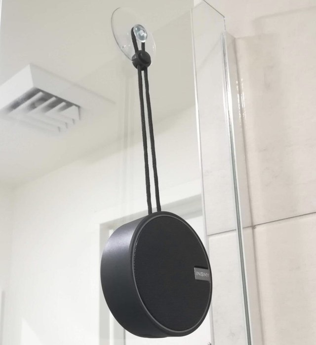 Reviewer image showing the black speaker hanging from a suction cup inside a shower