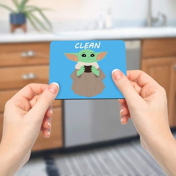 Model holding the magnet near the dishwasher