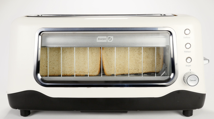 A white toaster with glass sides, showing the bread inside as it toasts
