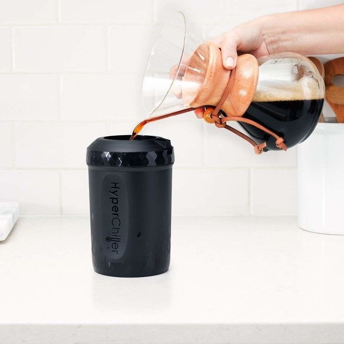 A hand gently pouring coffee into the HyperChiller.