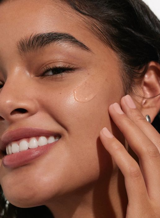 A model with Unseen Sunscreen applied to their face.