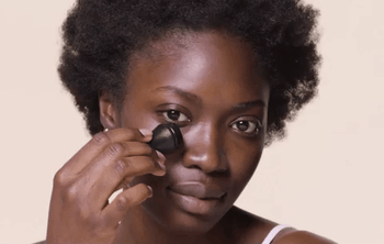 A model applying the oil roller to their face.