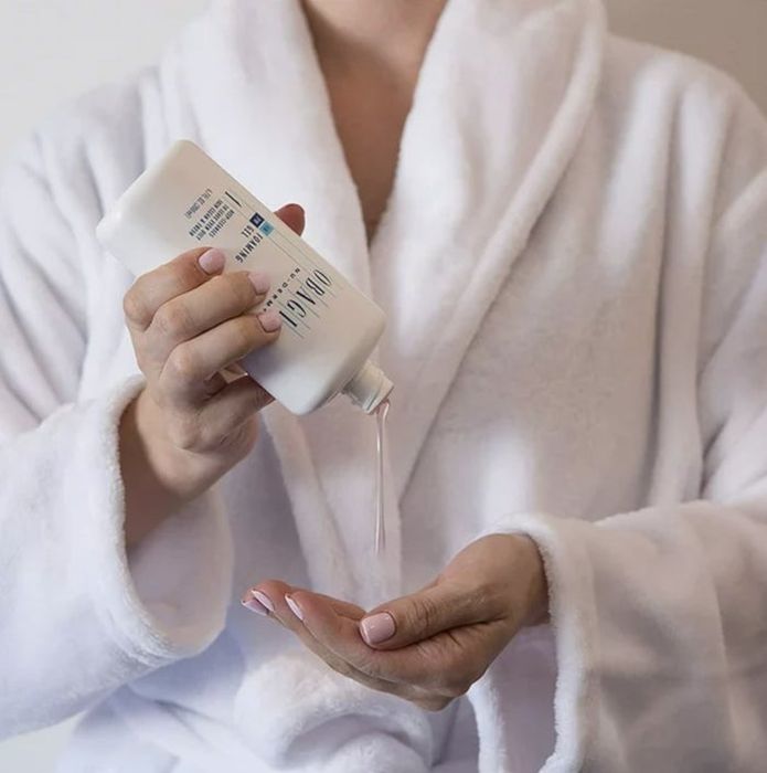 An image of someone pouring face cleanser into their hand