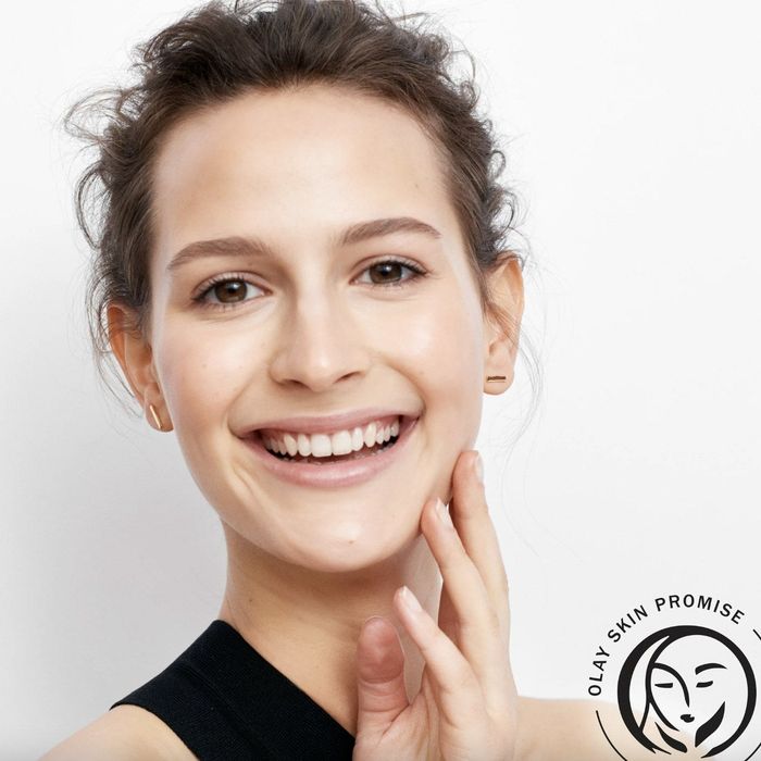 A person gently massaging their face