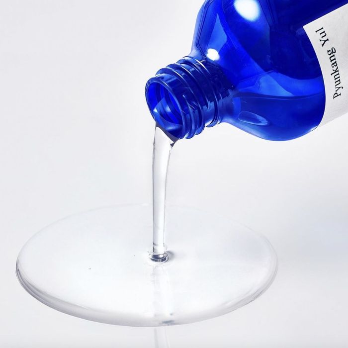 A bottle of toner being poured out.