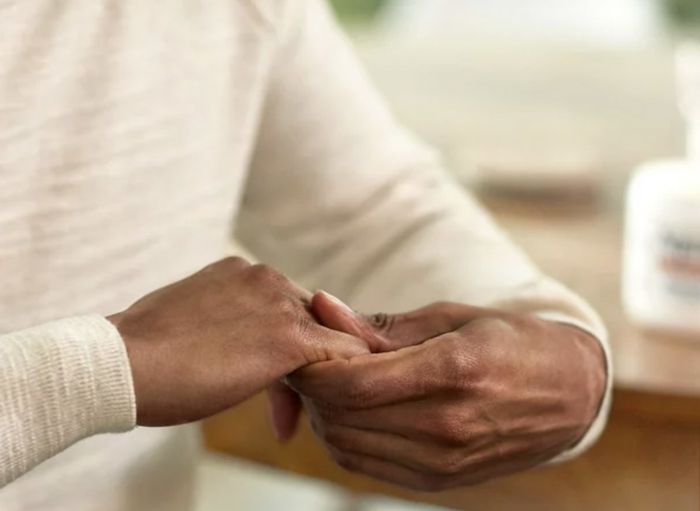 A person touching their hands