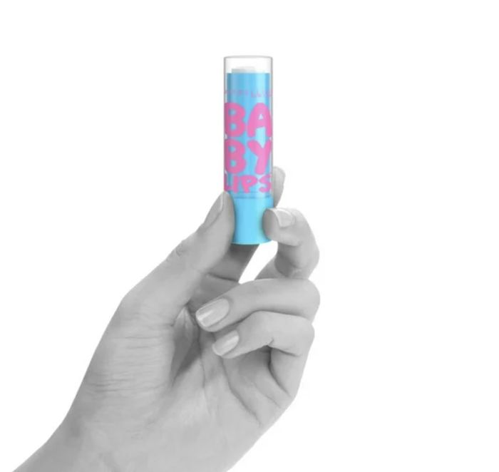 A person holding a tube of lip balm