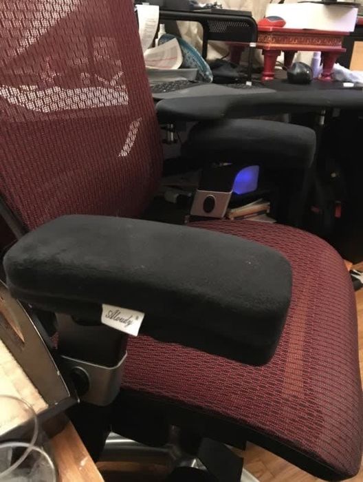 A reviewer’s image of memory foam armrest pads on a desk chair.