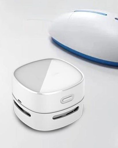 A small white desktop vacuum, designed for quick and easy cleaning, ideal for any workspace.