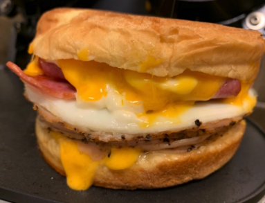 A mouthwatering breakfast sandwich, freshly made and ready to enjoy.