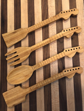 a reviewer's photo showcasing the four wooden tools with guitar-shaped handles