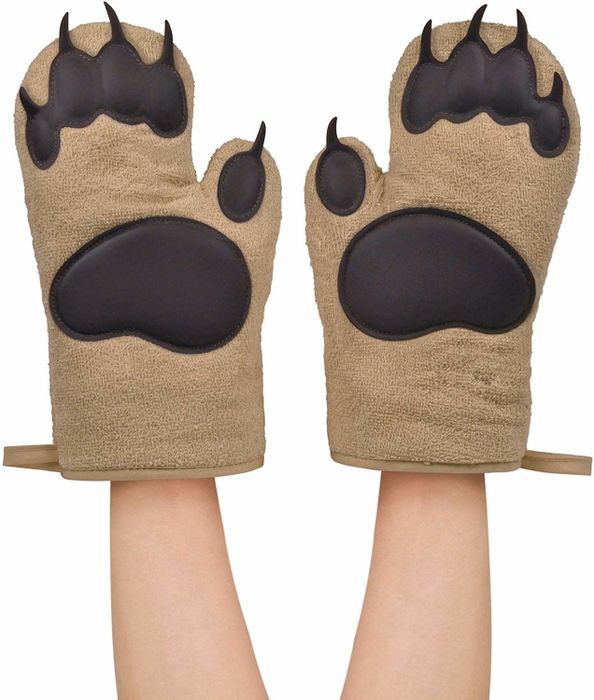 a model sporting two oven mitts that resemble bear paws