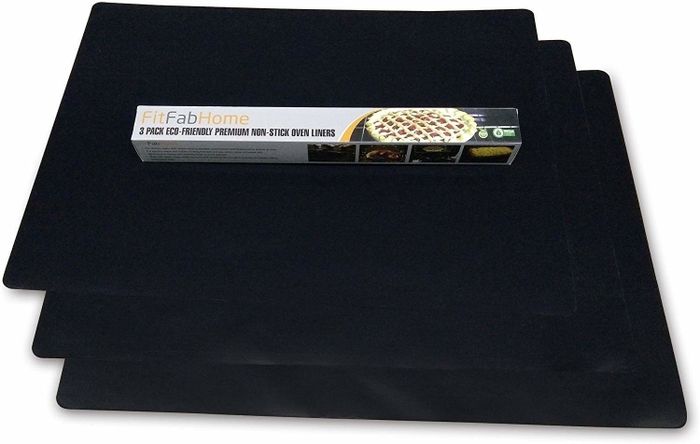 A stack of sturdy black oven mats, neatly piled and ready for use.