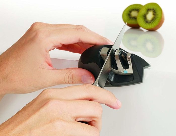 a model using the compact sharpener to refresh their knife's edge
