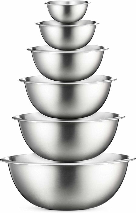A set of six stainless steel bowls stacked together, ready for use.