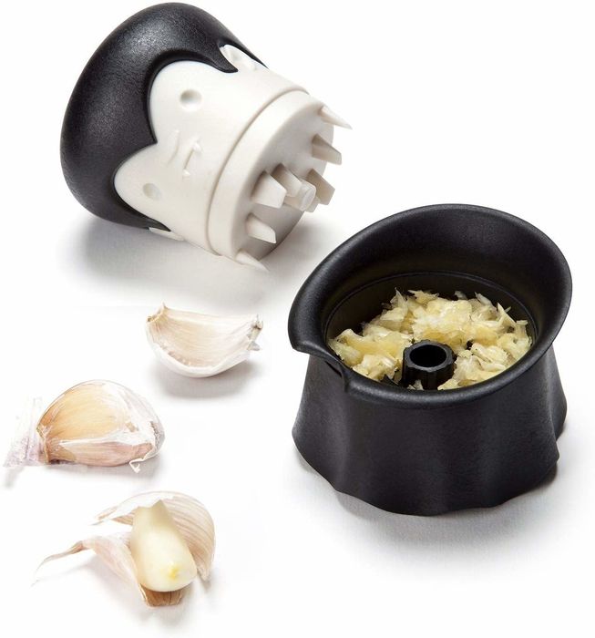 the garlic chopper with its top removed to reveal the freshly ground garlic inside