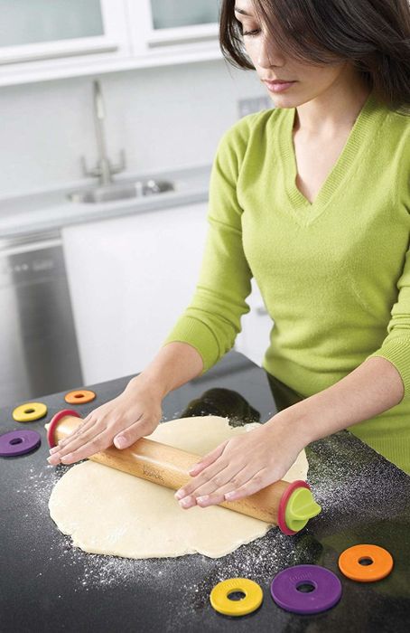 A model skillfully using the adjustable rolling pin to roll out dough evenly for the perfect bake.