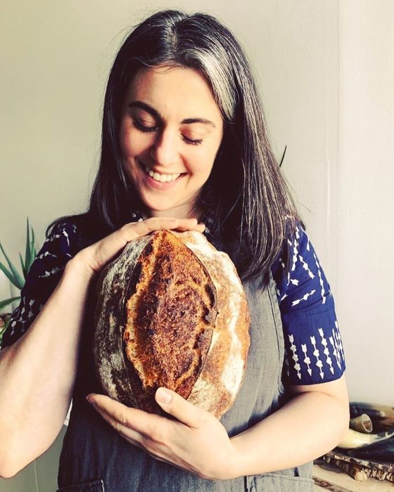 chef Claire Saffitz holding a freshly baked loaf of bread