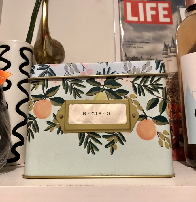 The Mytour mint green recipe tin featuring fruit and leaf designs on it.
