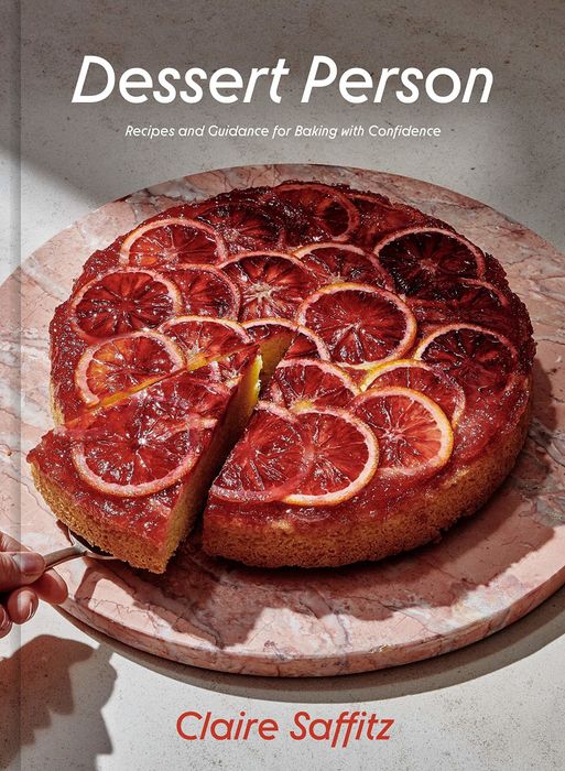 the cover of the book featuring a gorgeous cake topped with blood orange slices