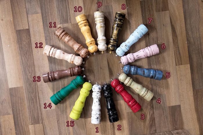 a collection of colorful salt and pepper grinders arranged in a circle