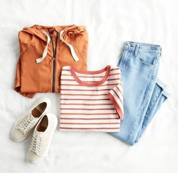 An example of Stitch Fix clothing items including jeans, a striped shirt, a jacket, and sneakers.