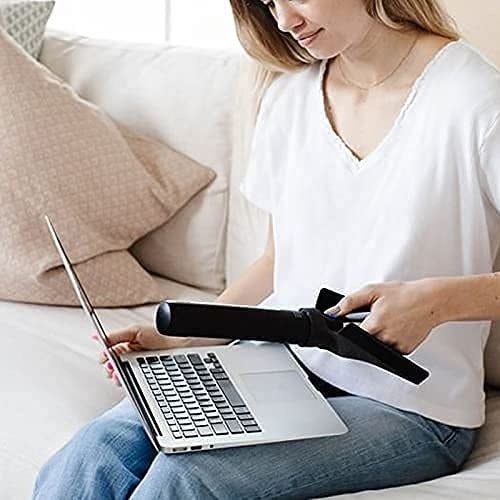 A model holding the curling iron-sized wand over their laptop