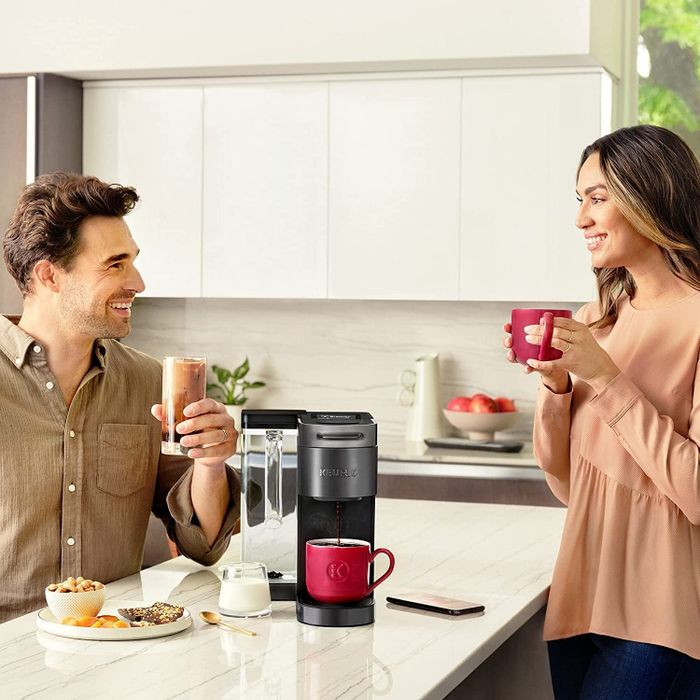 Two people sipping coffee brewed from the Keurig