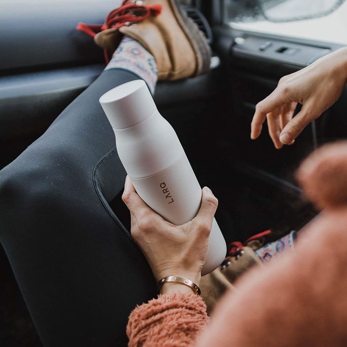 Someone holding the self-cleaning water bottle