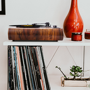 The record player displayed on a shelf surrounded by vinyl records