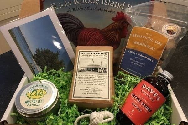 An assortment of artisan goods from Rhode Island, including granola, a candle, and coffee syrup.