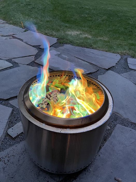 An outdoor fire captured in a review, showcasing the mesmerizing, colorful flames as they flicker and glow.