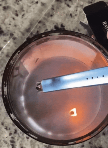 A gif showing the same reviewer lighting a candle with the lighter.