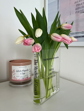 A clear vase filled with vibrant tulips, adding color and freshness to any space.