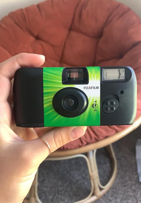 A reviewer captured holding the camera.