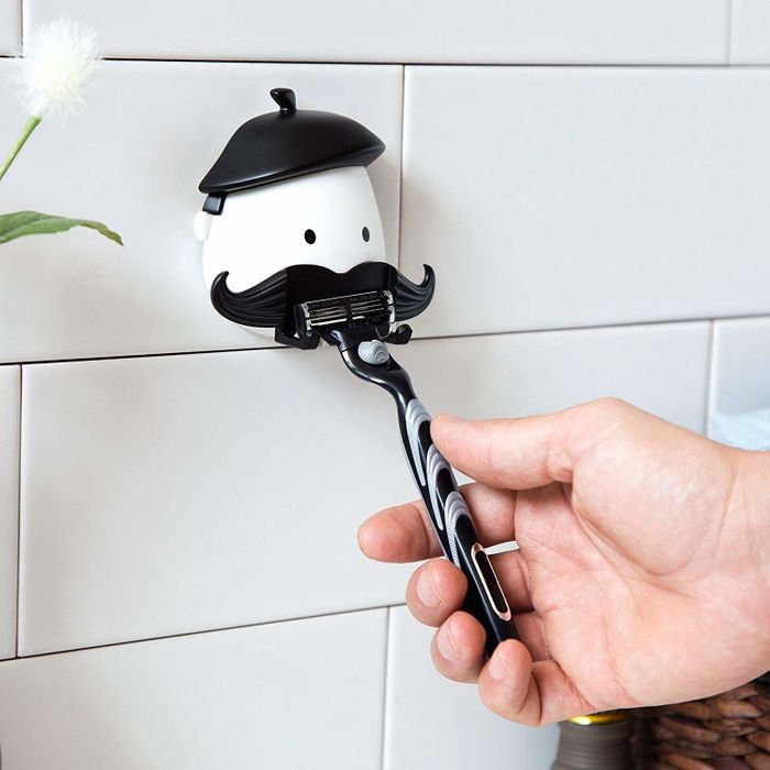 A refined gentleman with a razor in hand, this design brings both elegance and utility to your grooming space.
