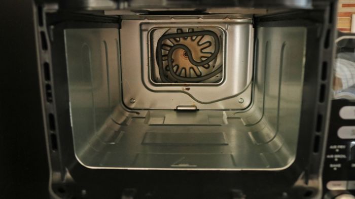 An inside view of the air fryer, showing the fan positioned at the back of the unit.