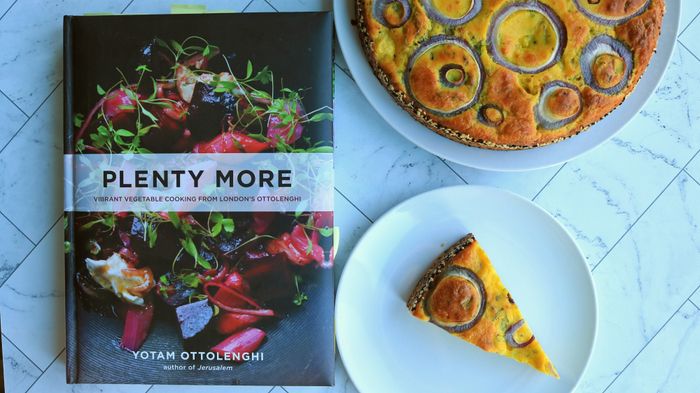 The cookbook, Plenty More, placed next to a cauliflower cake.