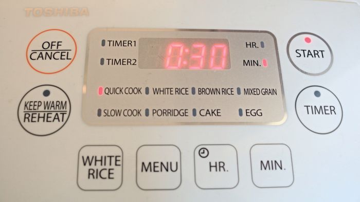 A rice cooker's control panel featuring functional buttons.