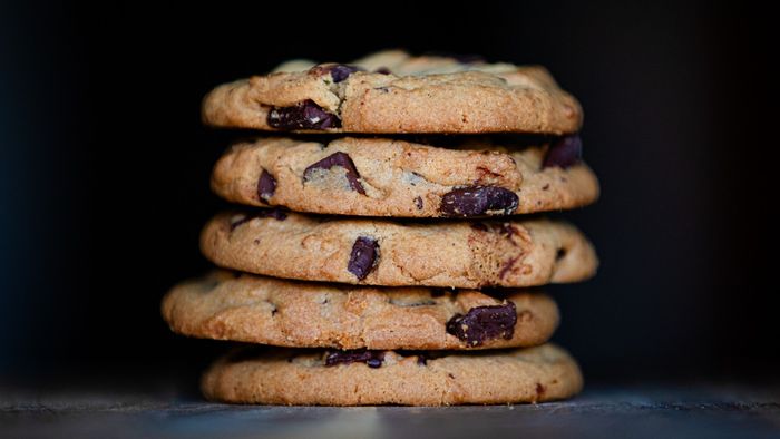 A close-up of a stack of freshly baked chocolate chip cookies.