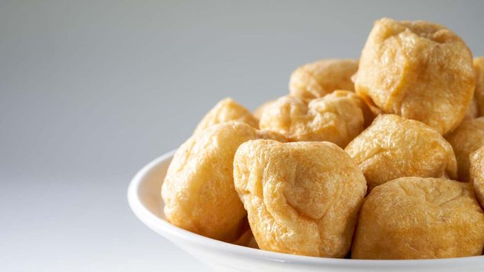Close-up of tofu puffs on a plate.
