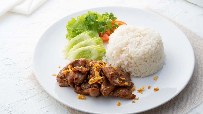 A generous sprinkle of crispy fried garlic on top of a plate of food.