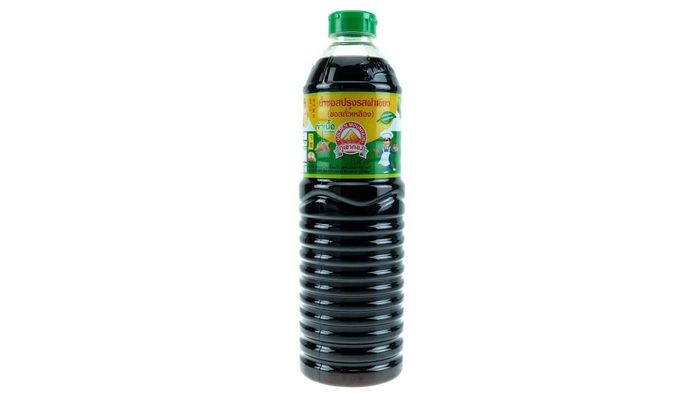 A large bottle of Golden Mountain sauce against a white background.