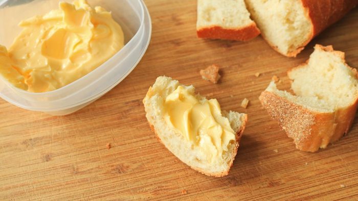 Chunks of bread topped with a generous spread of butter.