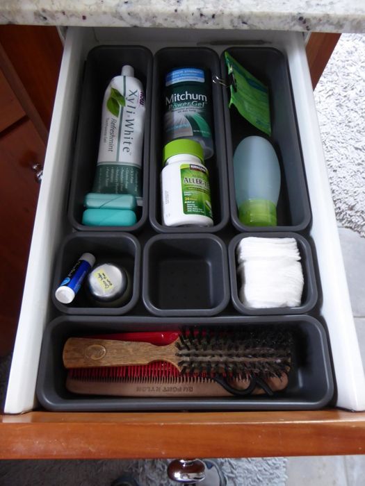 A reviewer's photo of the same drawer, now with all toiletries neatly organized and stored.