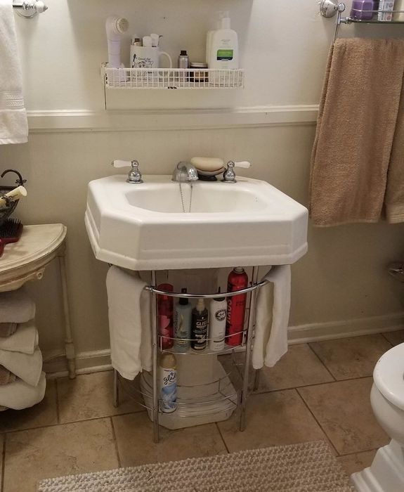 The organizer placed beneath a pedestal sink.