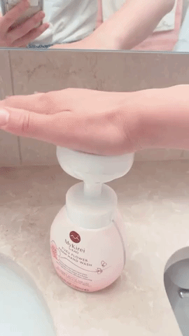 The editor using the dispenser to apply soap to their hand, demonstrating the fun and functional design of the pump.